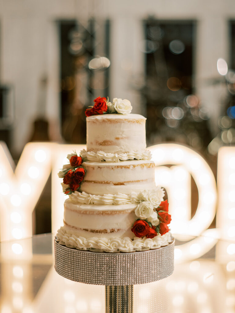 naked cake, red and white flowers, wedding cake, texas wedding venue