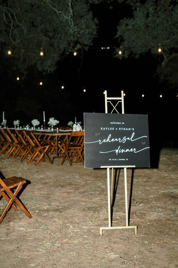 under the oaks, texas wedding venue, wedding rehearsal, texas bride, one more night, shiner texas, oak trees, bistro lights, dinner set up, outdoor dinner set up