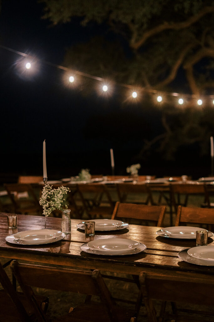 under the oaks, texas wedding venue, wedding rehearsal, texas bride, one more night, shiner texas, oak trees, bistro lights, dinner set up, outdoor dinner set up
