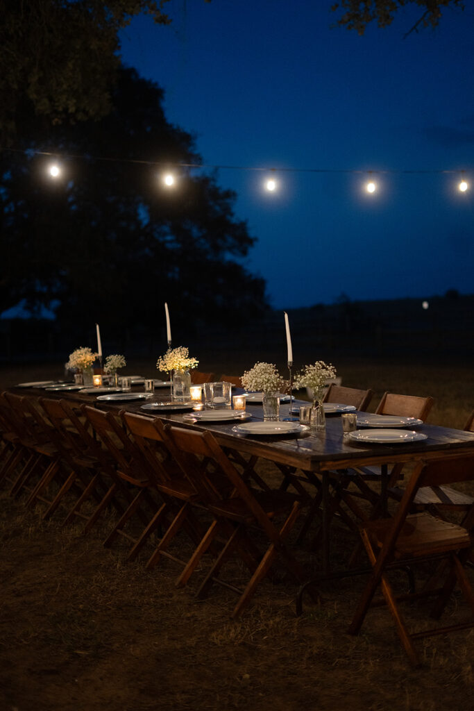 under the oaks, texas wedding venue, wedding rehearsal, texas bride, one more night, shiner texas, oak trees, bistro lights, dinner set up, outdoor dinner set up