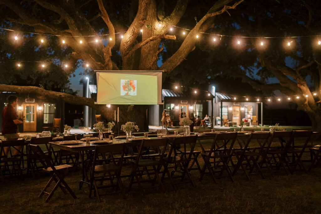 under the oaks, texas wedding venue, wedding rehearsal, texas bride, one more night, shiner texas, oak trees, bistro lights, dinner set up, outdoor dinner set up